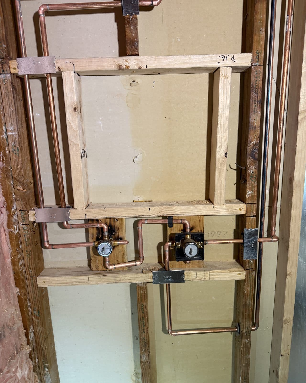 Copper supply lines and a shower valve set in open wall framing